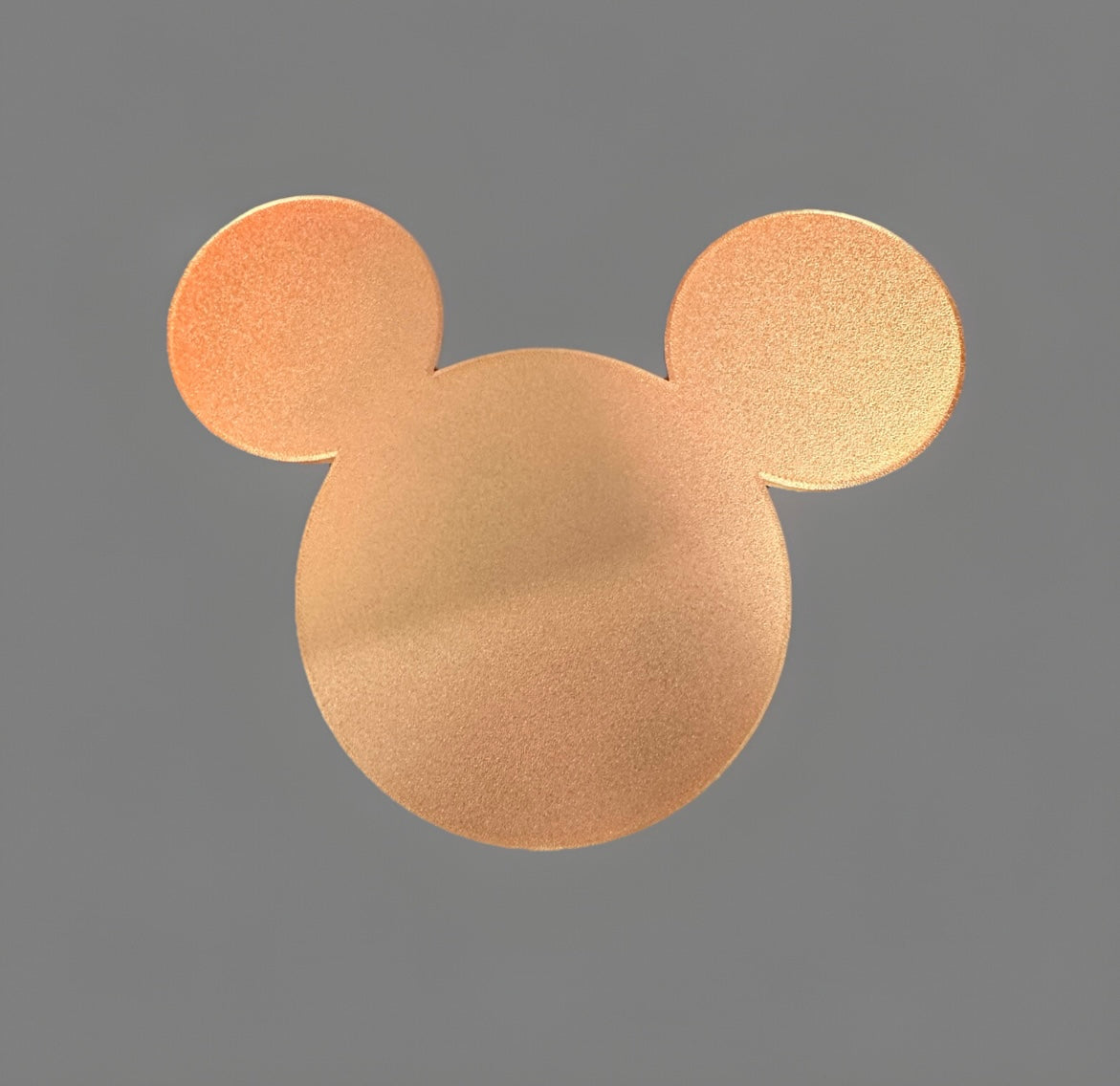 Golden 3D printed Oh Goofles collectible shaped like a stylized mouse head on gray background
