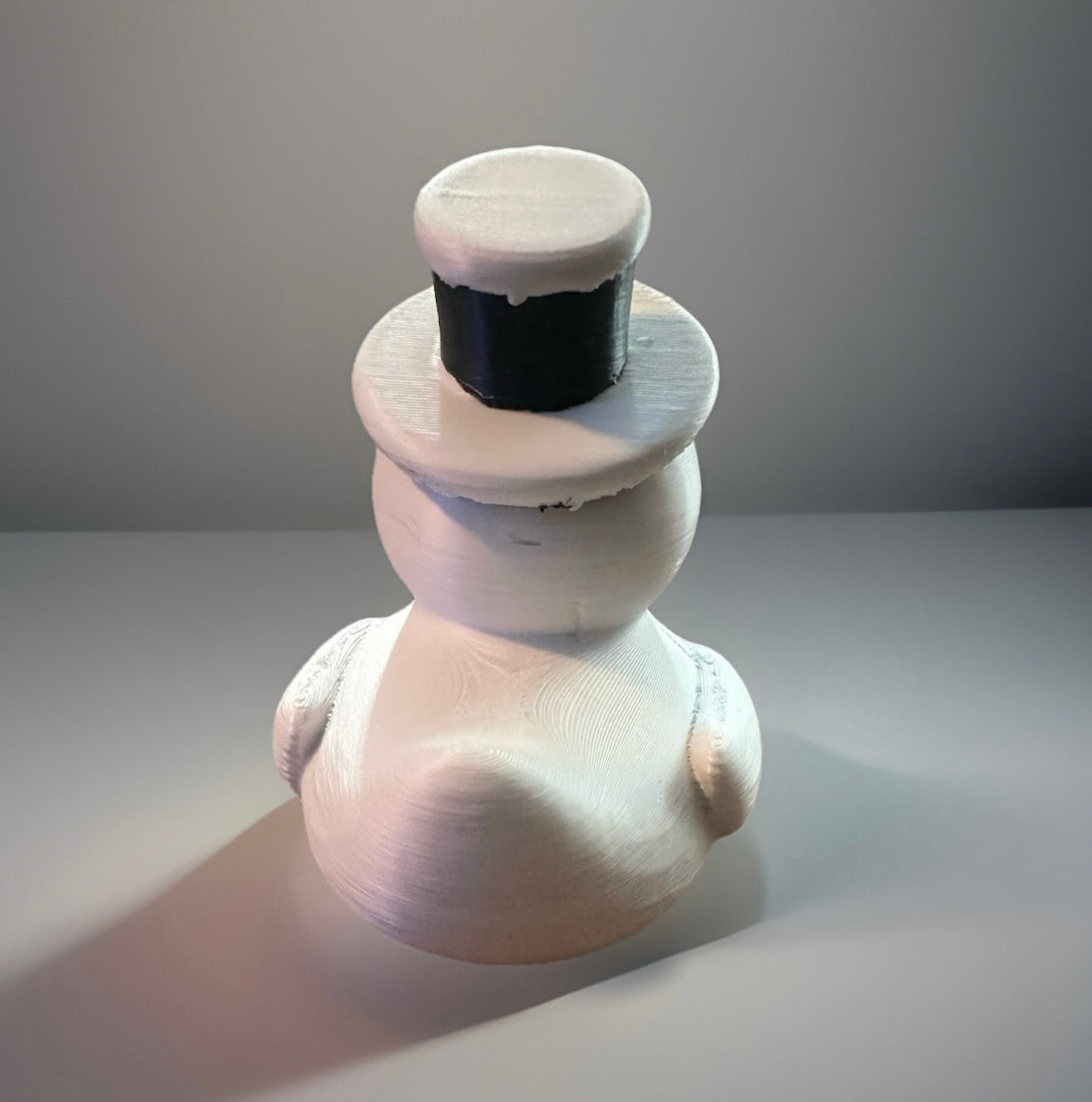 White 3D printed snowman duck with a black top hat from Reed’s Rubber Ducks and Sensory Shop