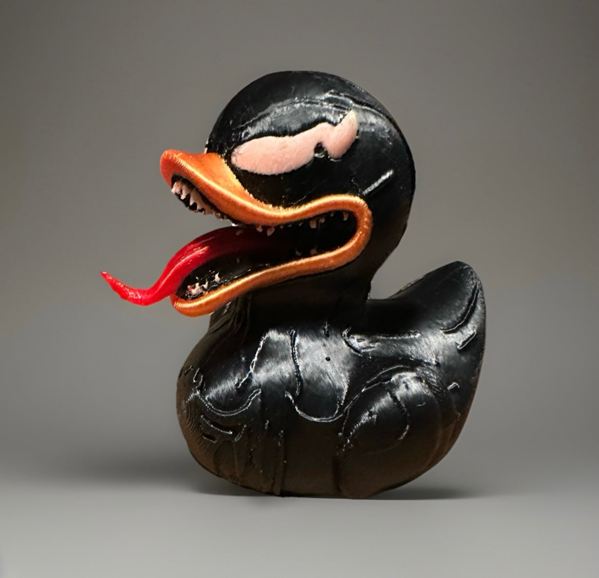 3D printed Venom duck in black with orange beak and detailed red tongue from Reed’s Rubber Ducks and Sensory Shop