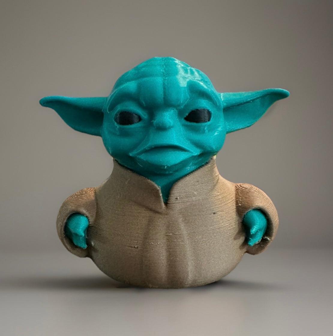 3D printed Yoda duck with green head and large ears wearing a brown robe from Reeds Rubber Ducks and Sensory Shop