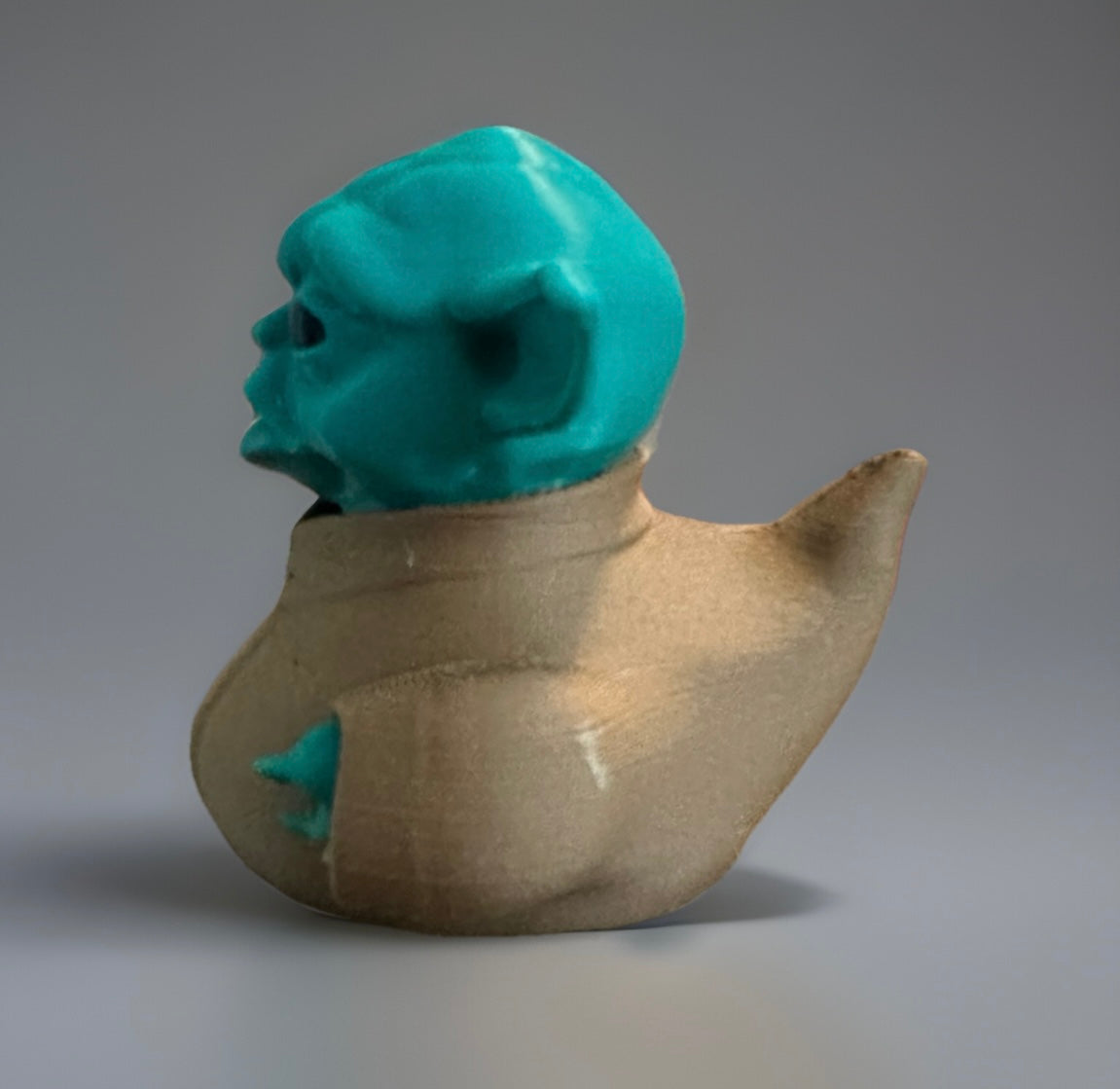 3D printed Yoda duck with teal head and beige body inspired by Star Wars character