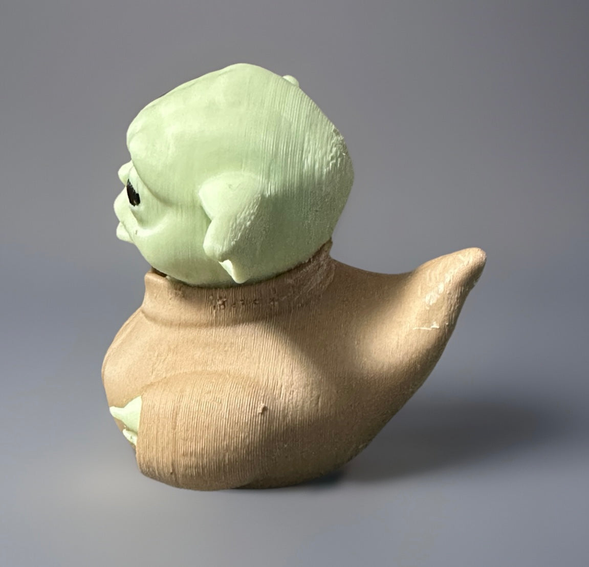 Side view of 3D printed Yoda duck with green head and beige body from Reed’s Rubber Ducks and Sensory Shop