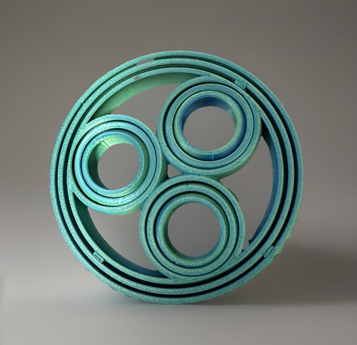Blue 3D rotating fidget rings with multiple circular layers for sensory play and stress relief
