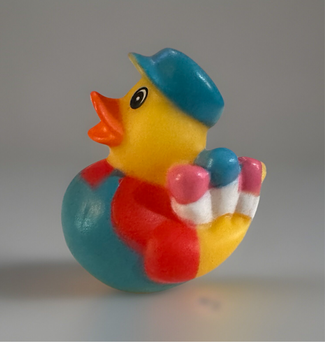 Colorful artist rubber duck gift wearing blue hat and holding paintbrushes from Reed’s Rubber Ducks and Sensory Shop