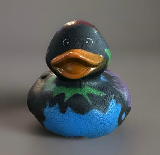 Black paint splatter rubber duck with colorful splashes in blue green and purple by Reeds Rubber Ducks
