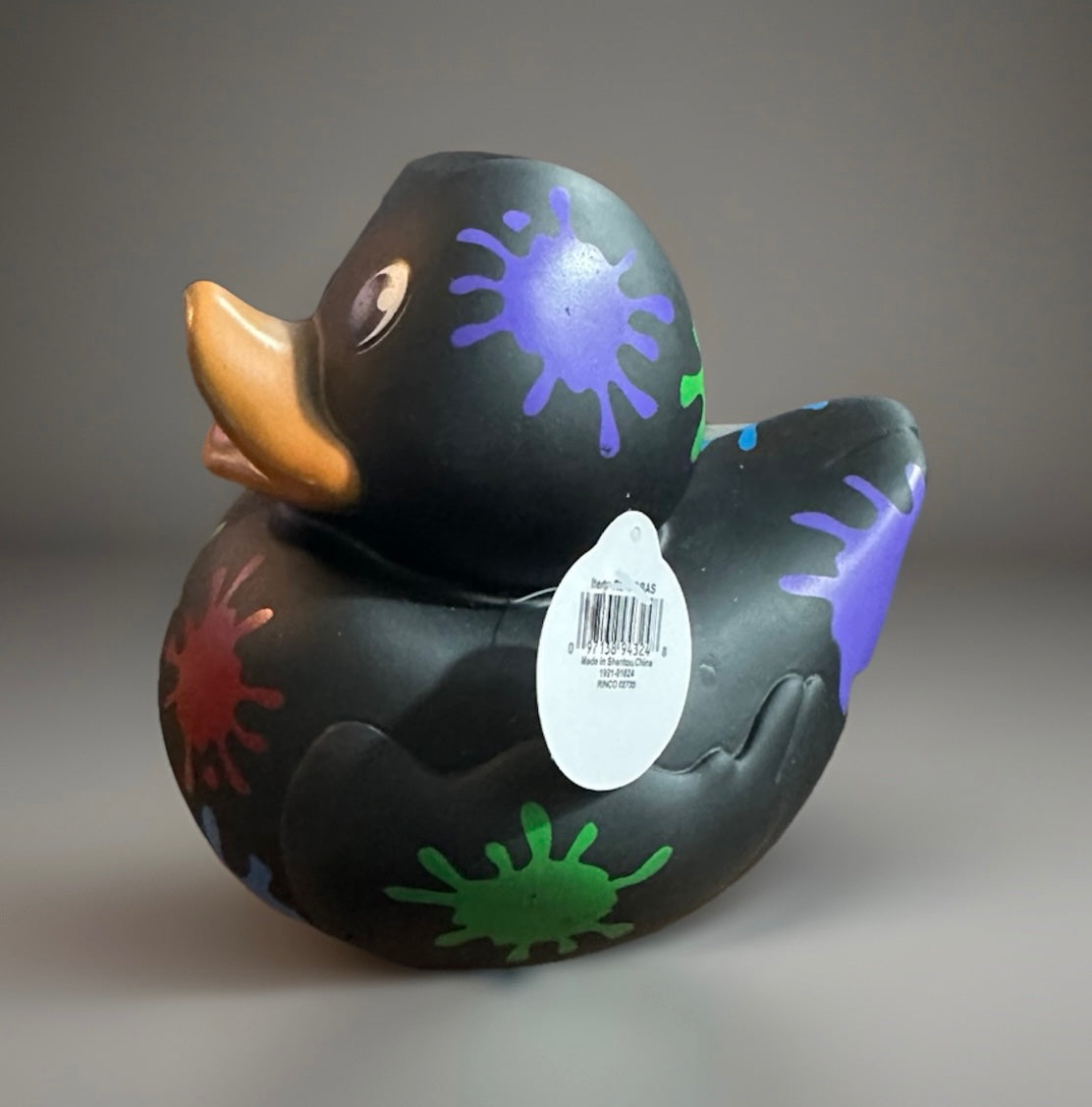 Black paint splatter rubber duck with colorful splashes in purple green and red by Reeds Rubber Ducks