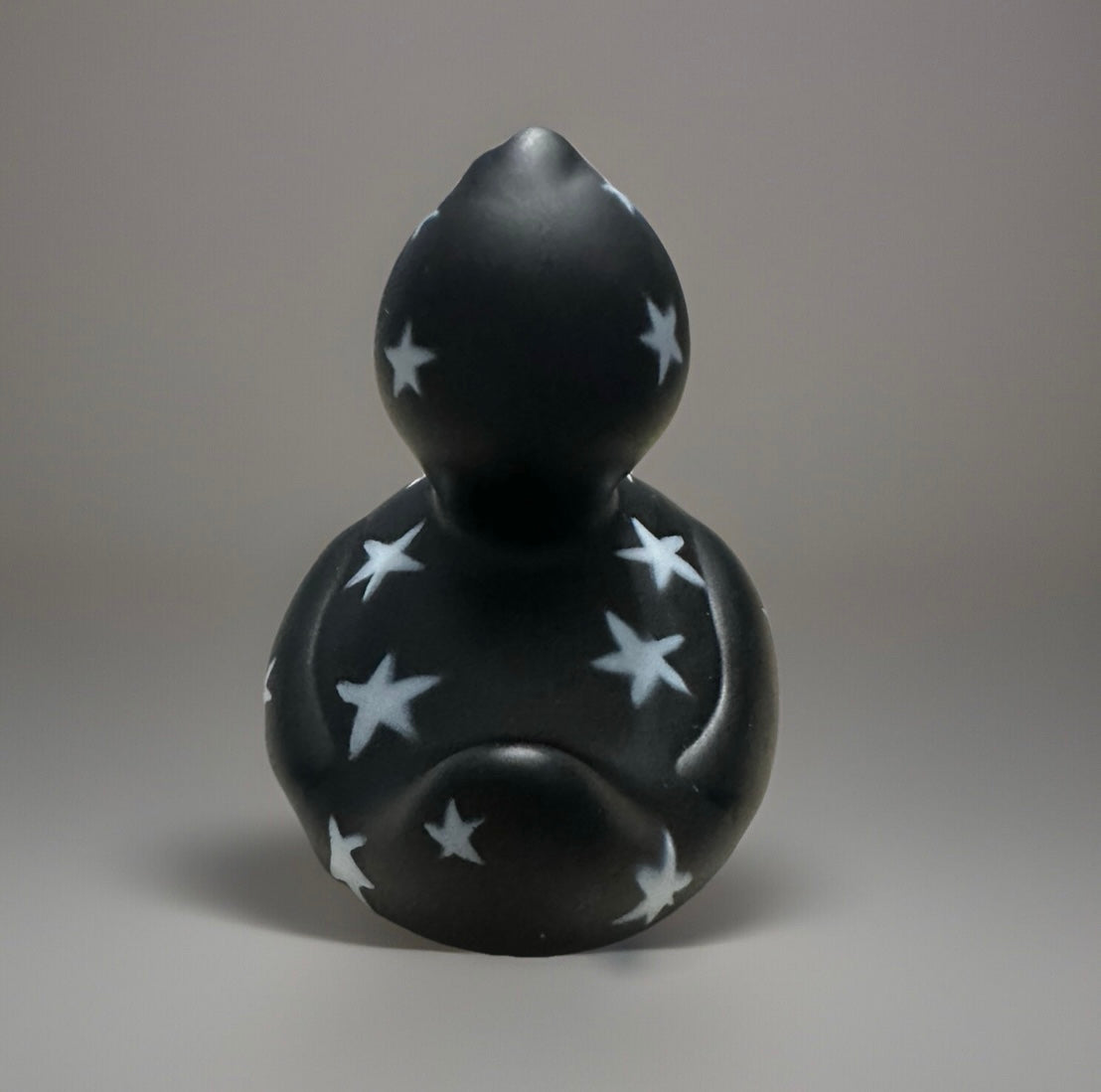 Black star rubber duck with white star patterns from Reed's Rubber Ducks and Sensory Shop