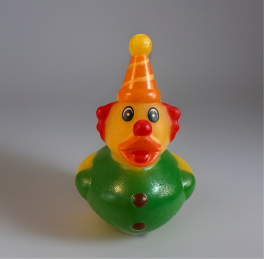 Colorful clown rubber duck with orange hat green body and red nose from Reed’s Rubber Ducks and Sensory Shop
