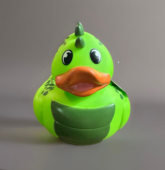 Bright green dinosaur rubber duck with orange beak and dark green spikes on head and back