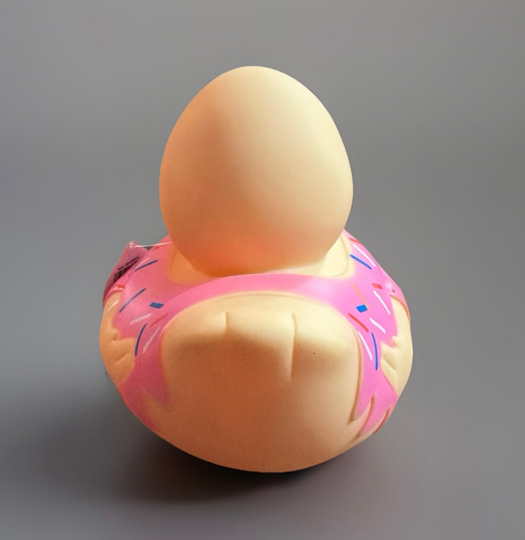 Back view of donut rubber duck with pink frosting and colorful sprinkles from Reed’s Rubber Ducks and Sensory Shop