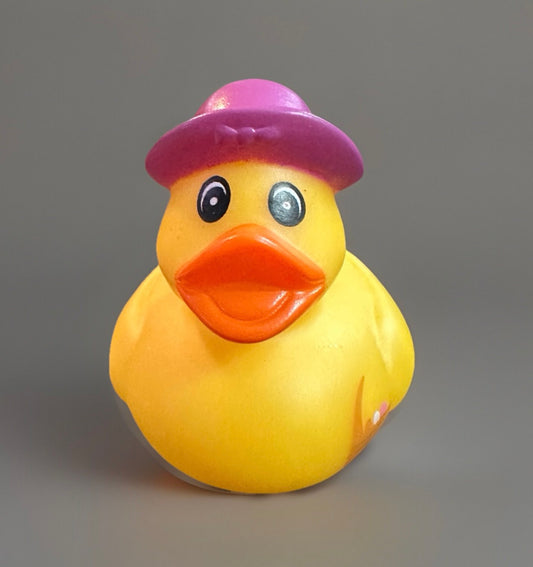 Yellow rubber duck wearing a purple hat Easter basket rubber duck from Reed’s Rubber Ducks and Sensory Shop