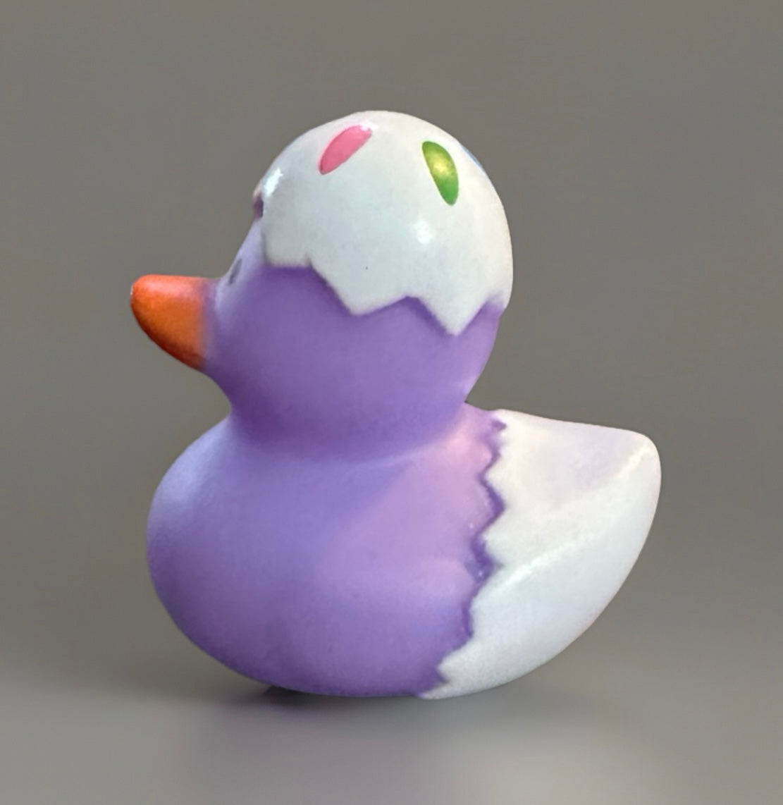 Purple Easter egg rubber duck with white cracked eggshell design and orange beak