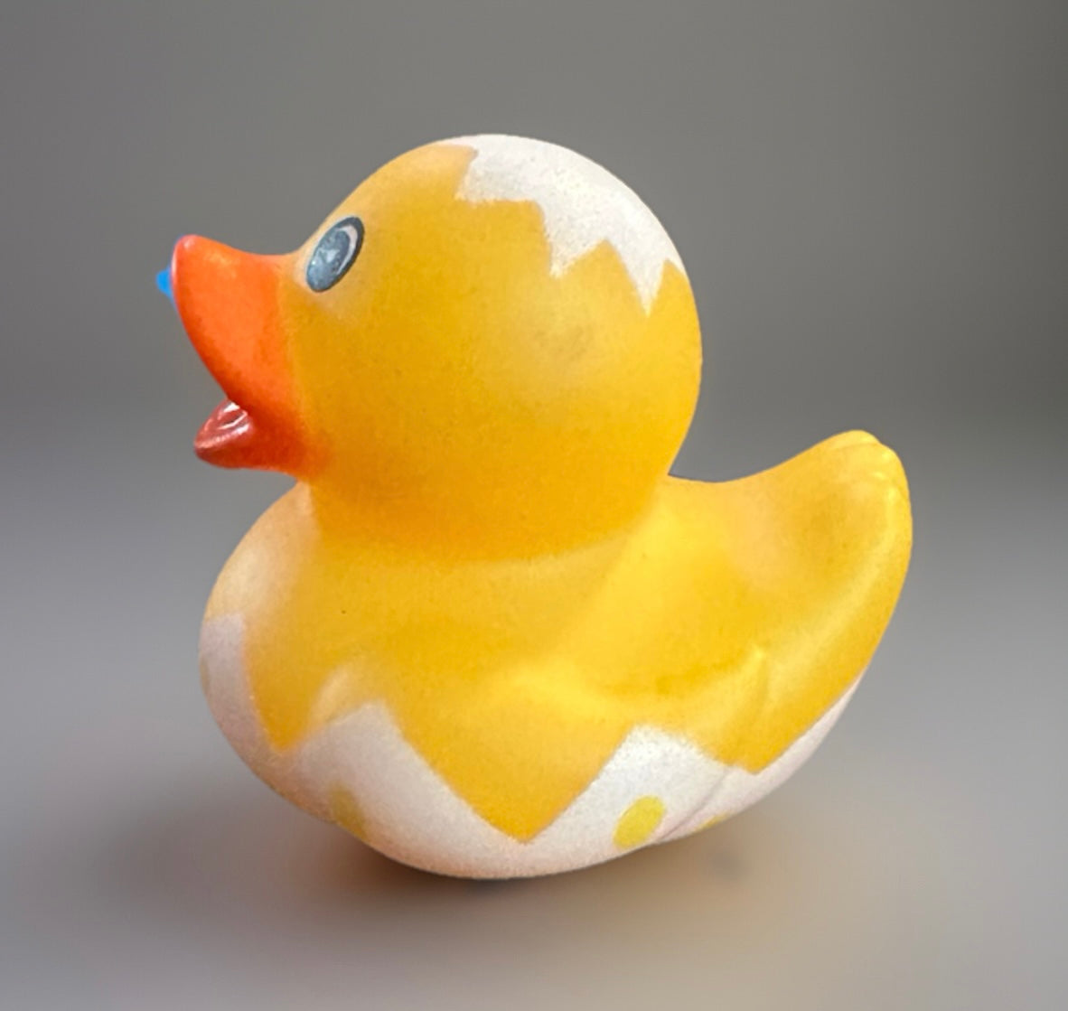 Yellow Easter egg rubber duck with orange beak and white eggshell pattern from Reed’s Rubber Ducks and Sensory Shop