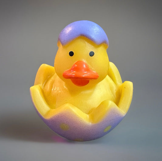 Yellow rubber duck with orange beak in pastel purple cracked Easter egg shell Easter rubber duck gift