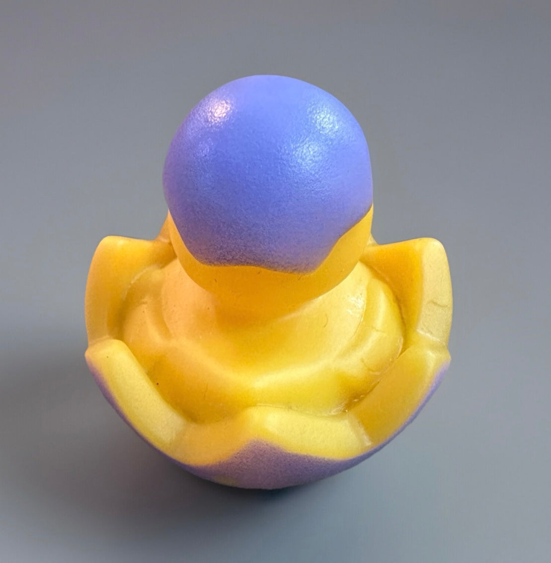 Yellow and purple Easter rubber duck gift shaped like a chick hatching from an egg