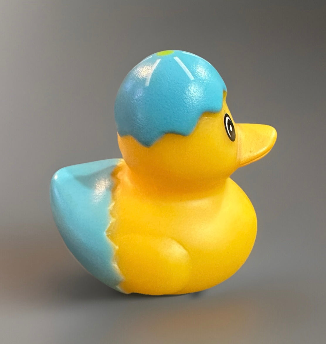 Yellow rubber duck with blue cracked eggshell design on head and body Easter rubber duck gift