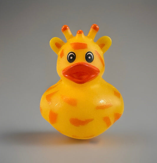 Bright yellow giraffe rubber duck toy with orange spots and cartoon eyes from Reed’s Rubber Ducks and Sensory Shop