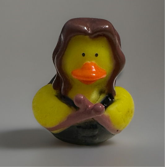 Rock and roll rubber duck with yellow body and orange beak wearing black outfit and hand gesture