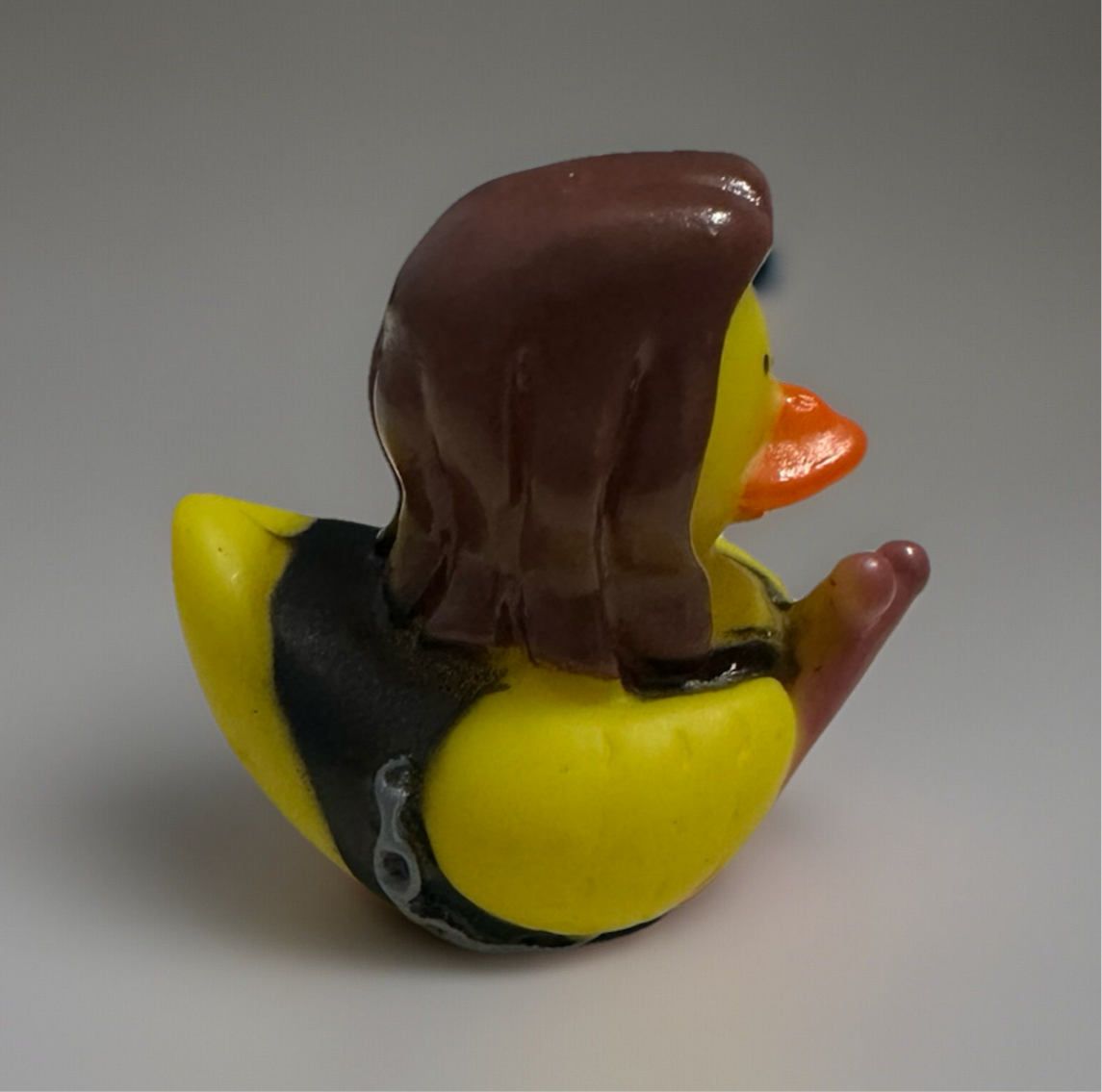 Rock and roll rubber duck with brown hair and black leather vest from Reed’s Rubber Ducks