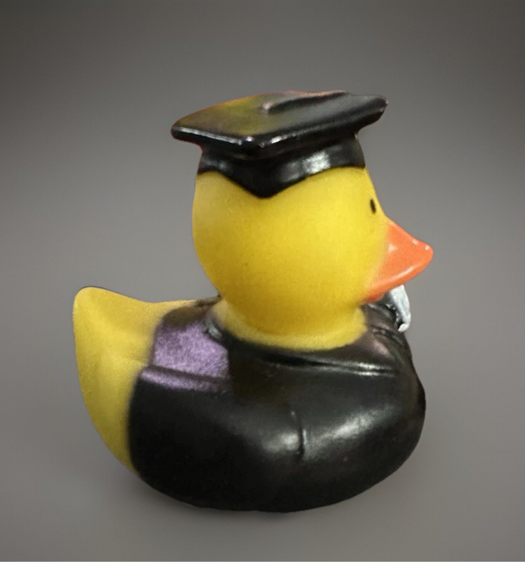 Yellow rubber duck wearing black graduation cap and gown graduation rubber duck gift from Reed’s Rubber Ducks