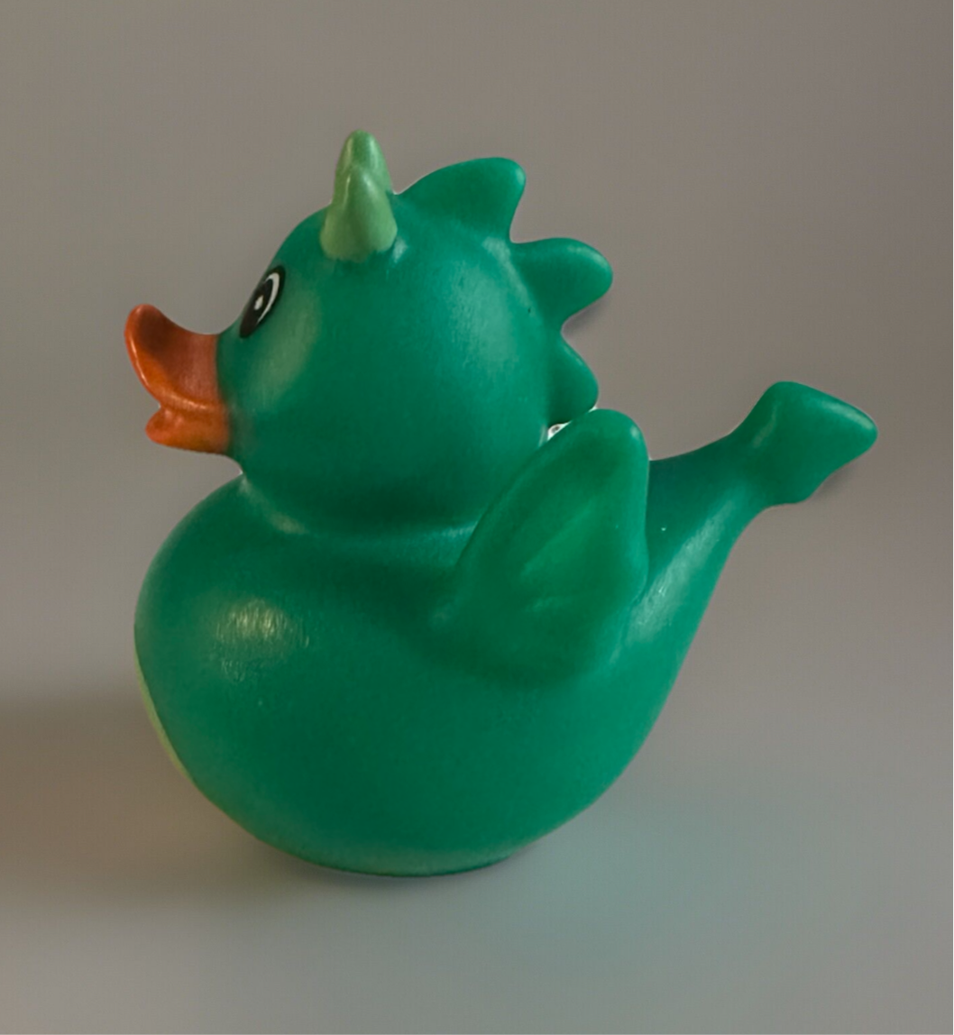 Green Dragon Rubber Duck with small wings, horns, and an orange beak from Reed’s Rubber Ducks and Sensory Shop