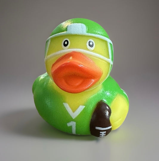 Green football rubber duck wearing a helmet and holding a football from Reed’s Rubber Ducks and Sensory Shop