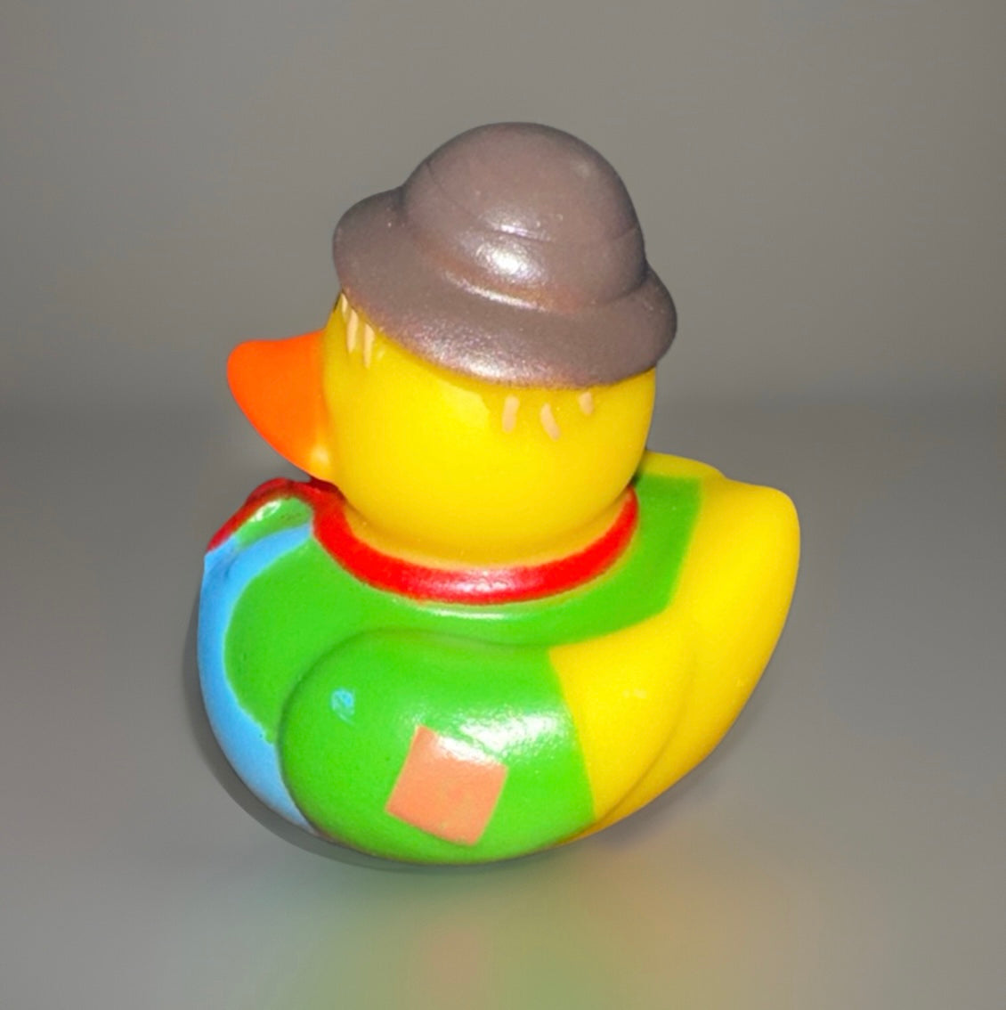 Green scarecrow rubber duck with brown hat and colorful patchwork outfit from Reed’s Rubber Ducks
