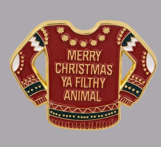 Home Alone enamel pin featuring a red Christmas sweater with Merry Christmas Ya Filthy Animal text