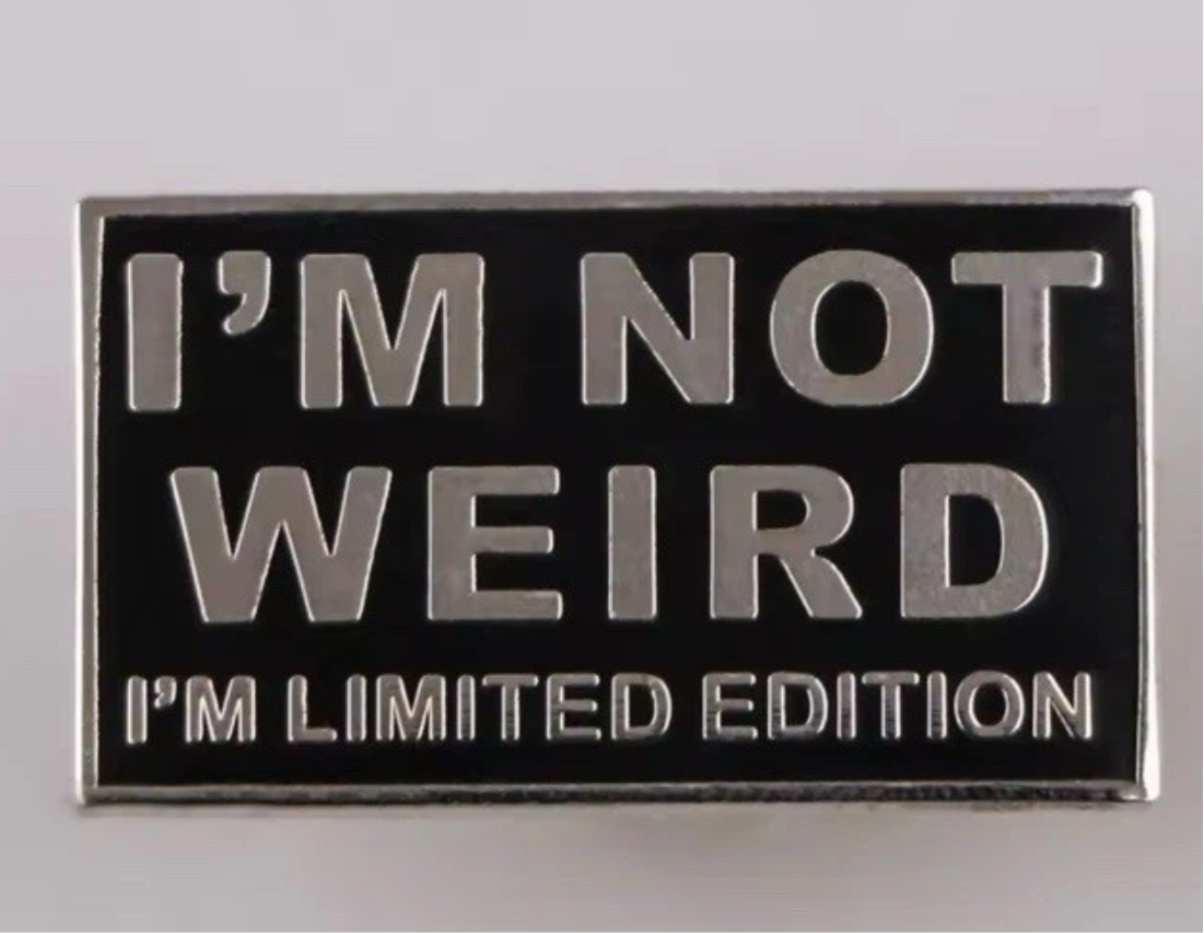 I'm not weird lapel pin with silver text on black background saying I'm limited edition