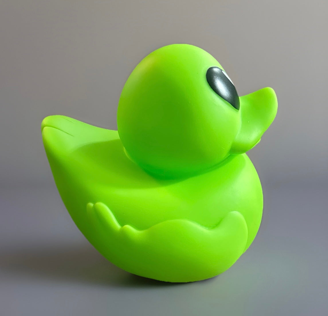 Bright neon green alien rubber duck with large black eyes from Reed’s Rubber Ducks and Sensory Shop