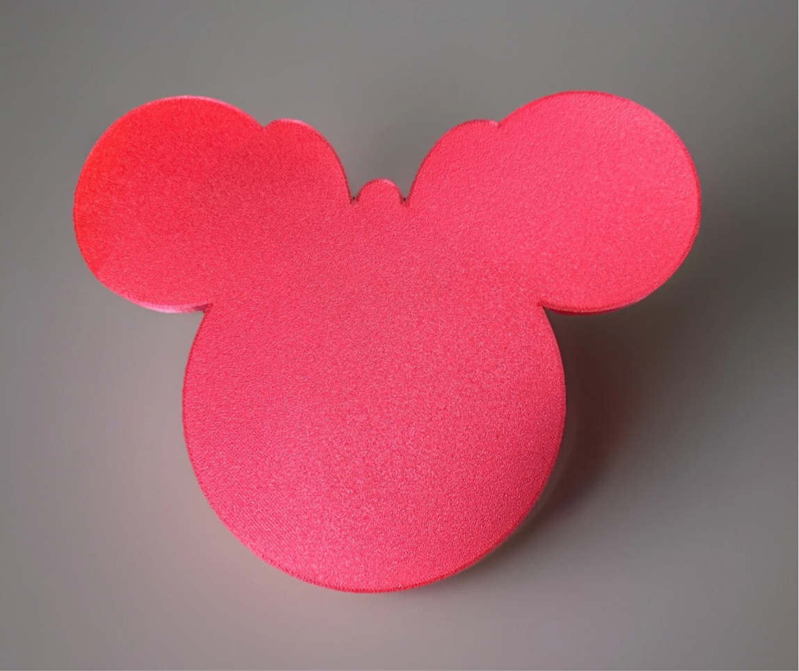 Bright pink Oh Quoodles figure shaped like a mouse head with large round ears