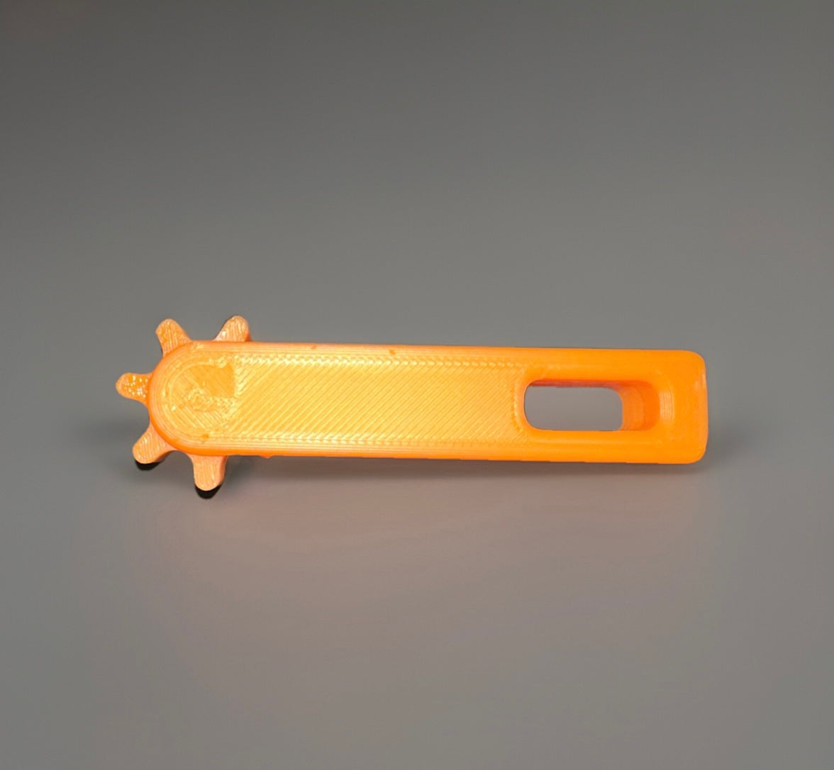 Orange 3D printed fidget keychain with a textured surface and unique gear-like design