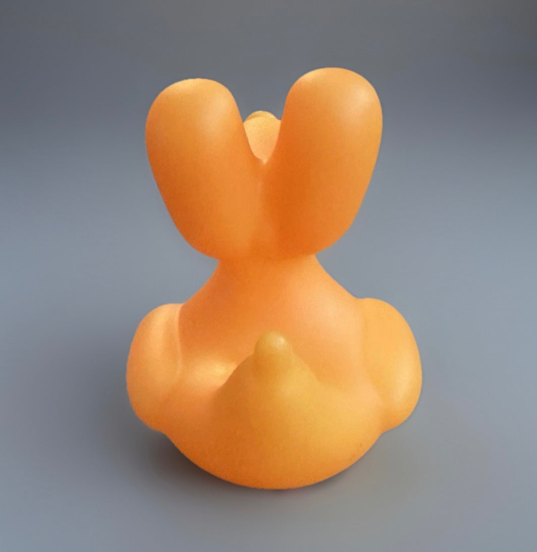 Orange balloon animal rubber duck from Reed’s Rubber Ducks and Sensory Shop with unique balloon-shaped ears