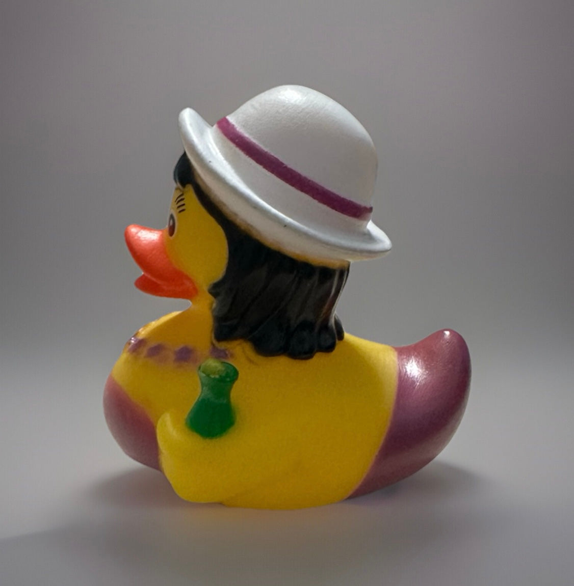 Party girl rubber duck wearing a white hat with purple band and holding a green drink