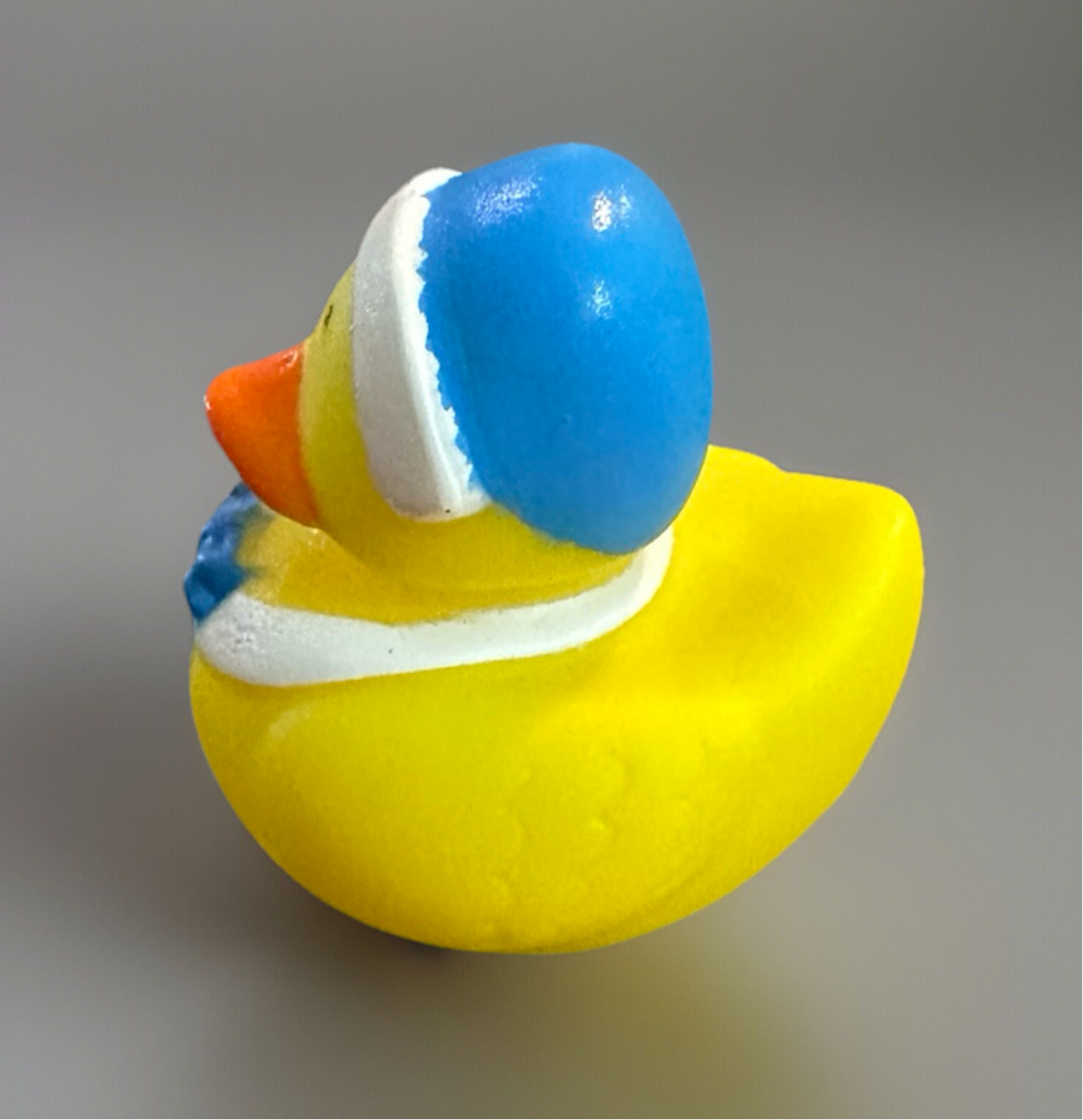Yellow Pilgrim themed duck toy with a blue hat and colorful details, perfect for sensory play