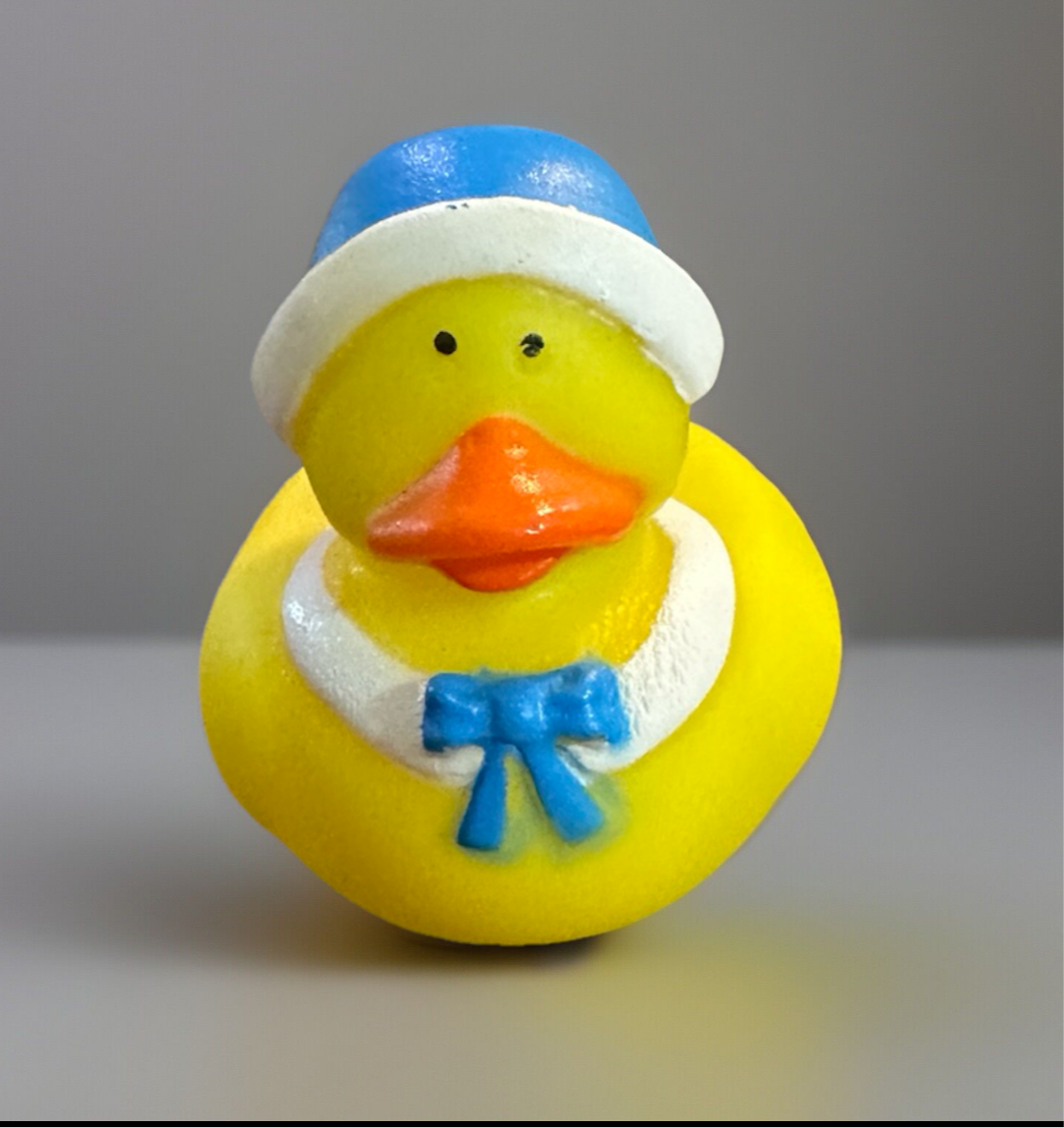 Cute yellow Pilgrim themed duck toy wearing a blue hat and bow tie, perfect for sensory play