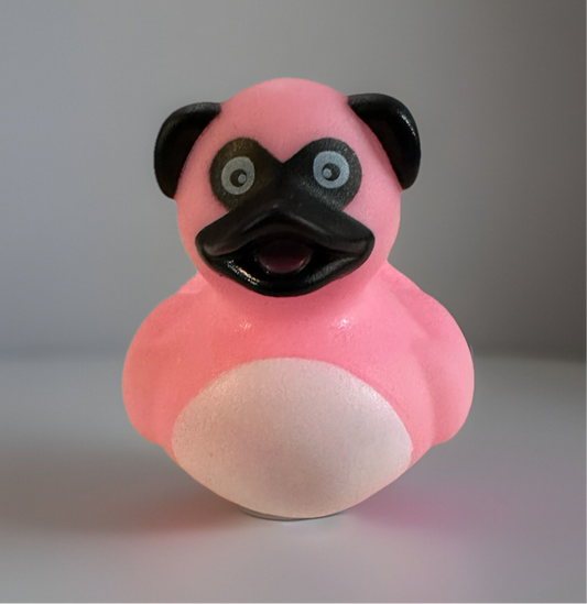 Pink pug rubber duck with black ears and snout from Reed’s Rubber Ducks and Sensory Shop
