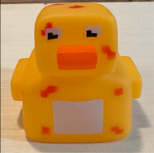 Pixelated rubber duck toy with orange beak and blocky eyes from Reed’s Rubber Ducks and Sensory Shop