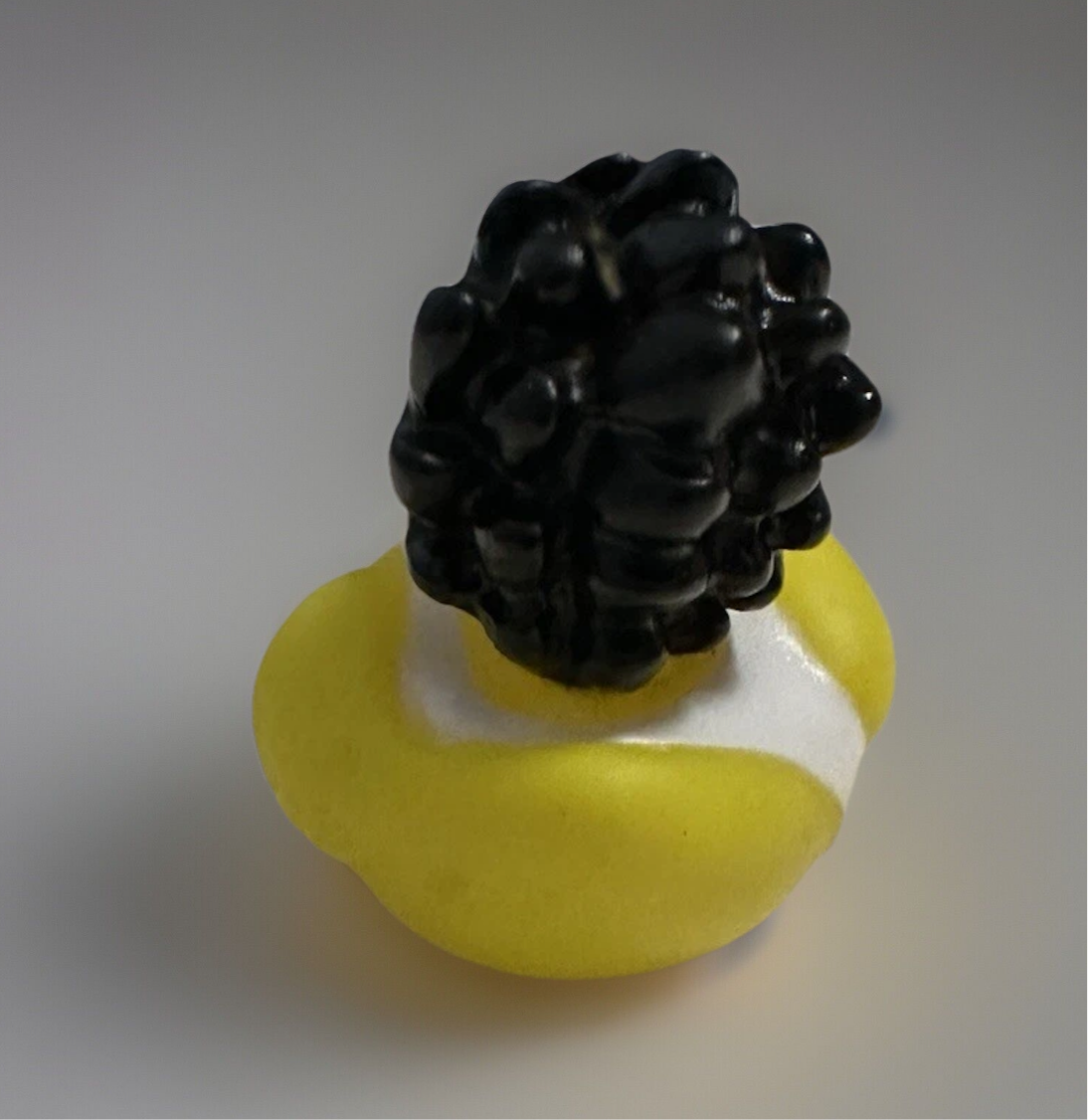 Rock and roll rubber duck toy with curly black hair and yellow body from Reed's Rubber Ducks and Sensory Shop