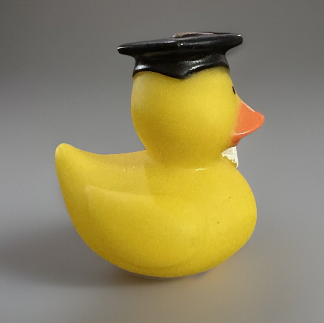 Yellow 2 inch graduation duck wearing a black graduation cap with an orange beak