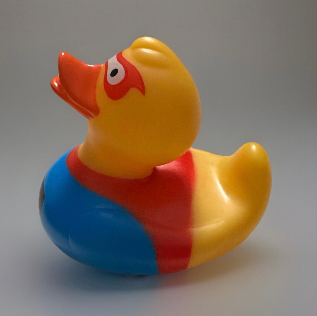 Colorful super hero rubber duck with red, blue, and yellow costume by Reeds Rubber Ducks and Sensory Shop