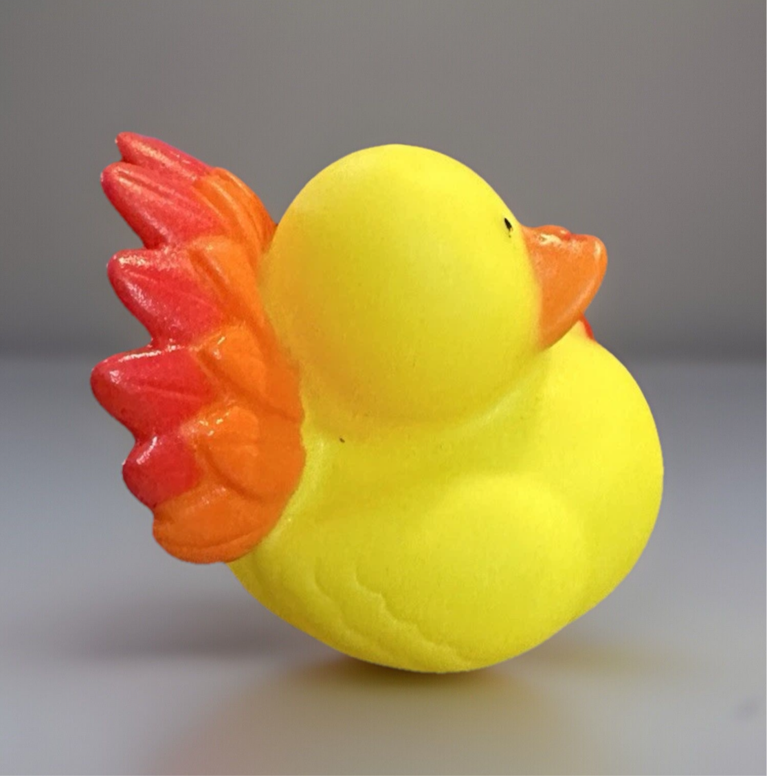 Thanksgiving turkey rubber duck featuring vibrant yellow body and colorful feathered tail