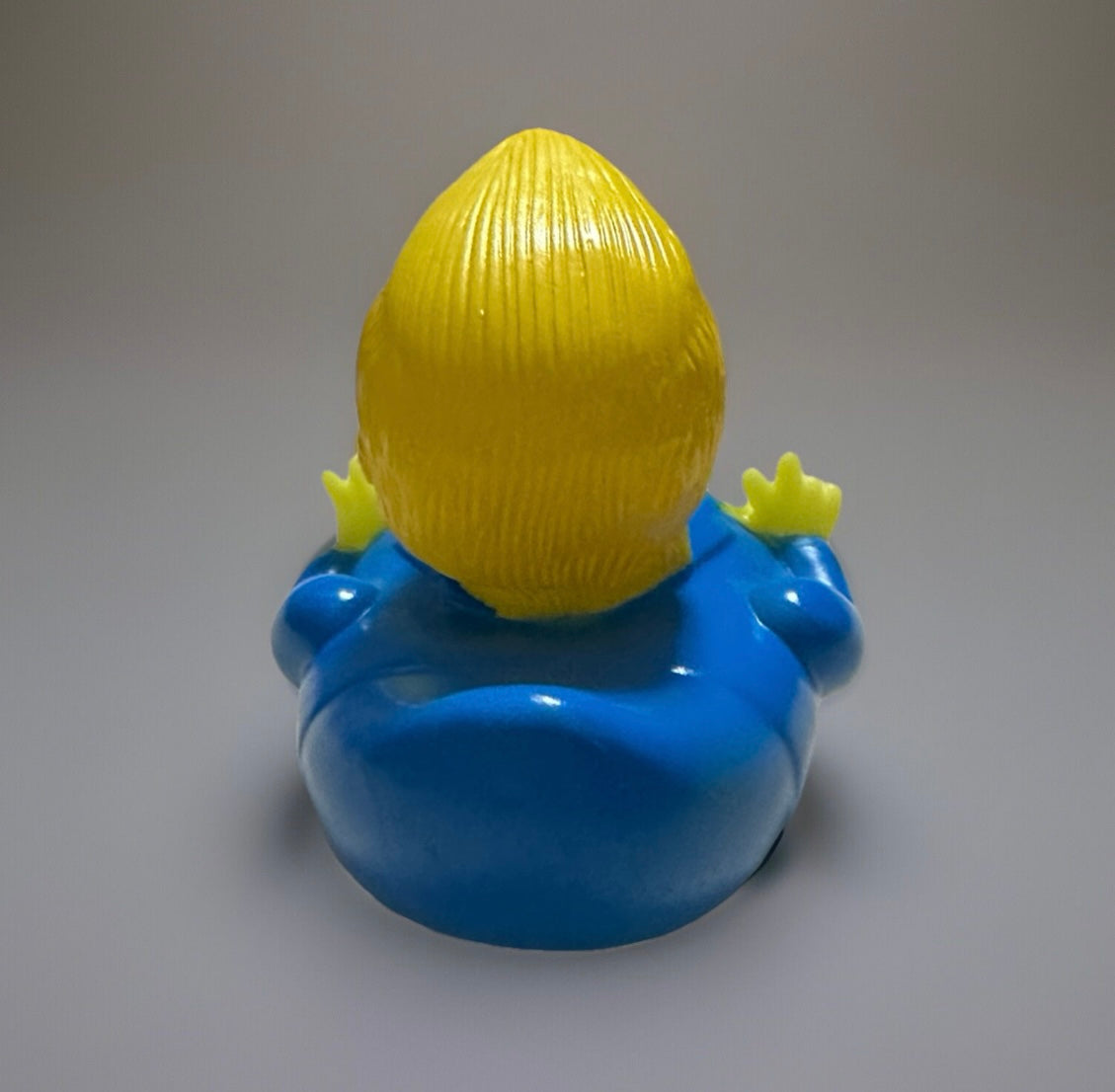 Back view of Trump rubber duck gift with yellow hair and blue suit from Reed’s Rubber Ducks and Sensory Shop