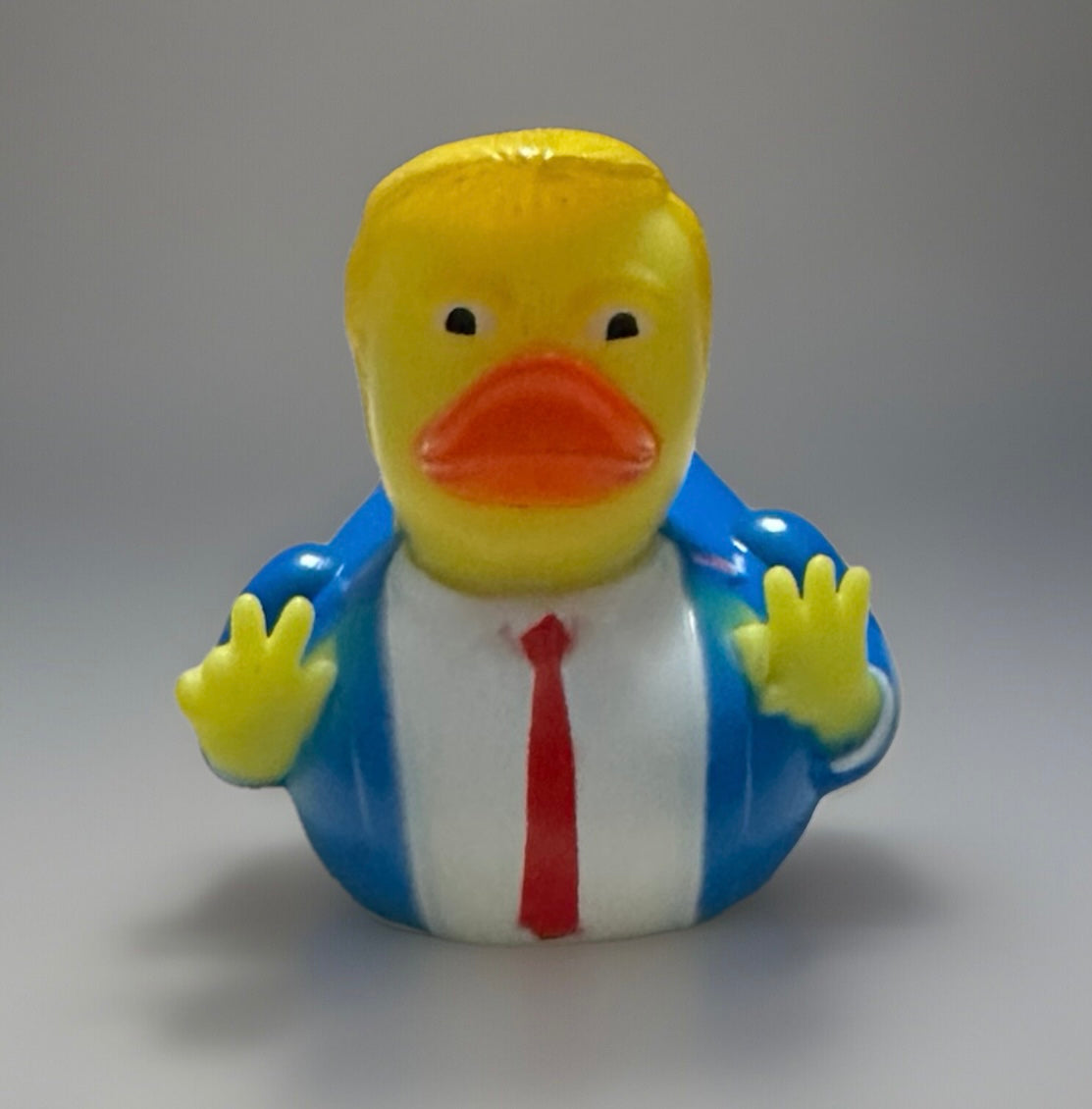 Trump rubber duck gift in blue suit with red tie and yellow hair from Reed’s Rubber Ducks and Sensory Shop