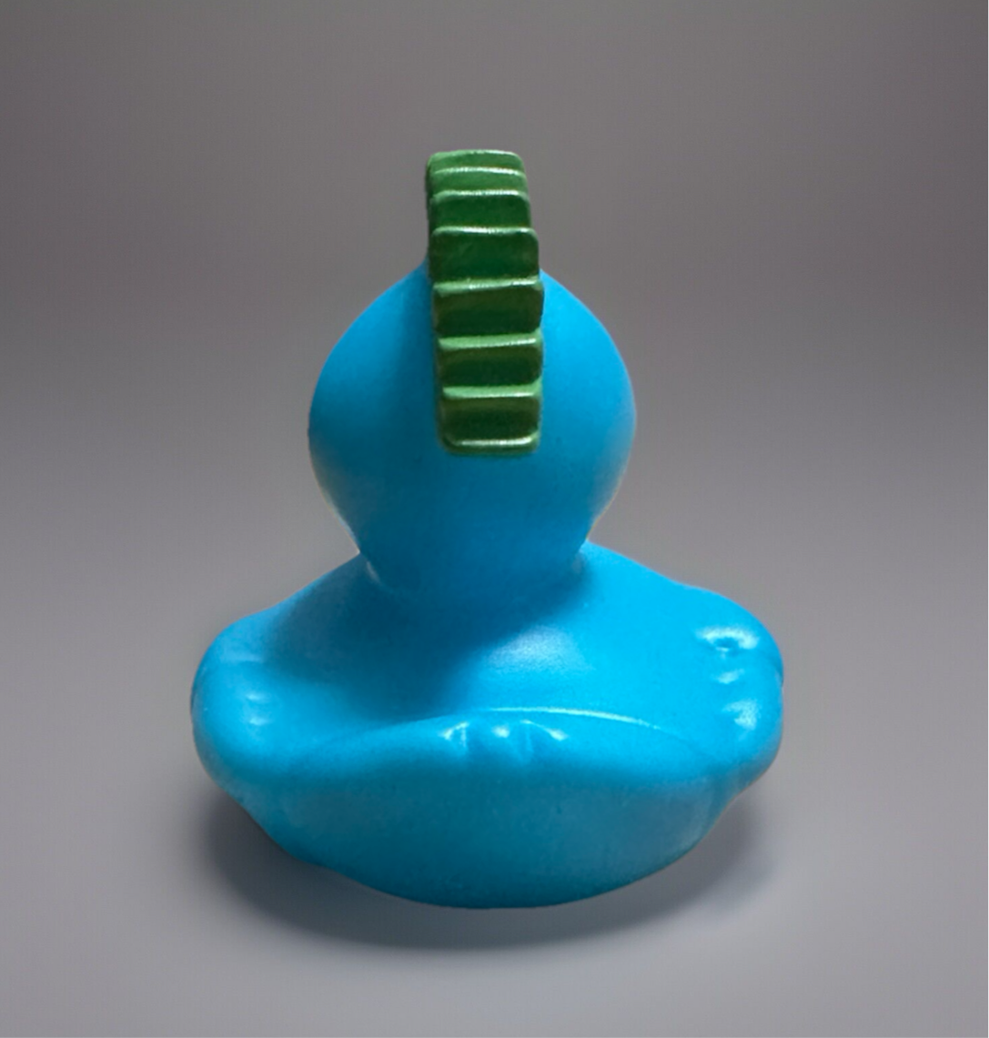 Turquoise rubber duck gift with green feather tail, perfect for sensory play and bath time fun