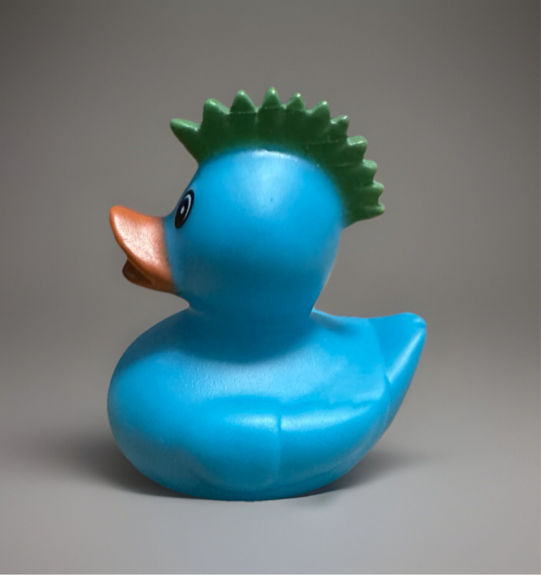 Turquoise rubber duck gift with spiky green crest, ideal for bath time fun and sensory play