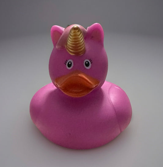 Pink unicorn rubber duck with golden horn and orange beak from Reed’s Rubber Ducks and Sensory Shop