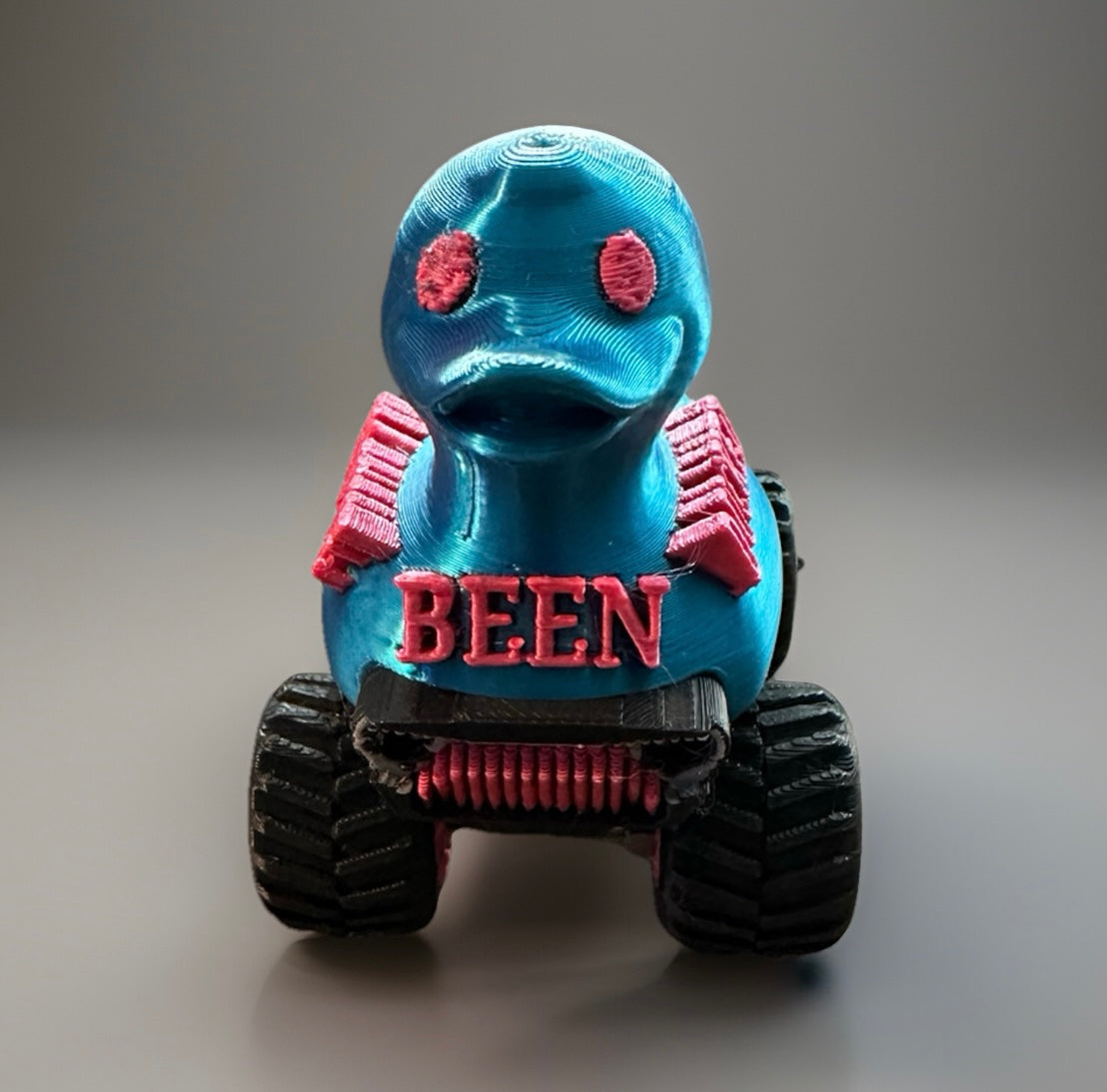 Blue and pink toy jeep with a duck head and text been on the front using You've been ducked jeep