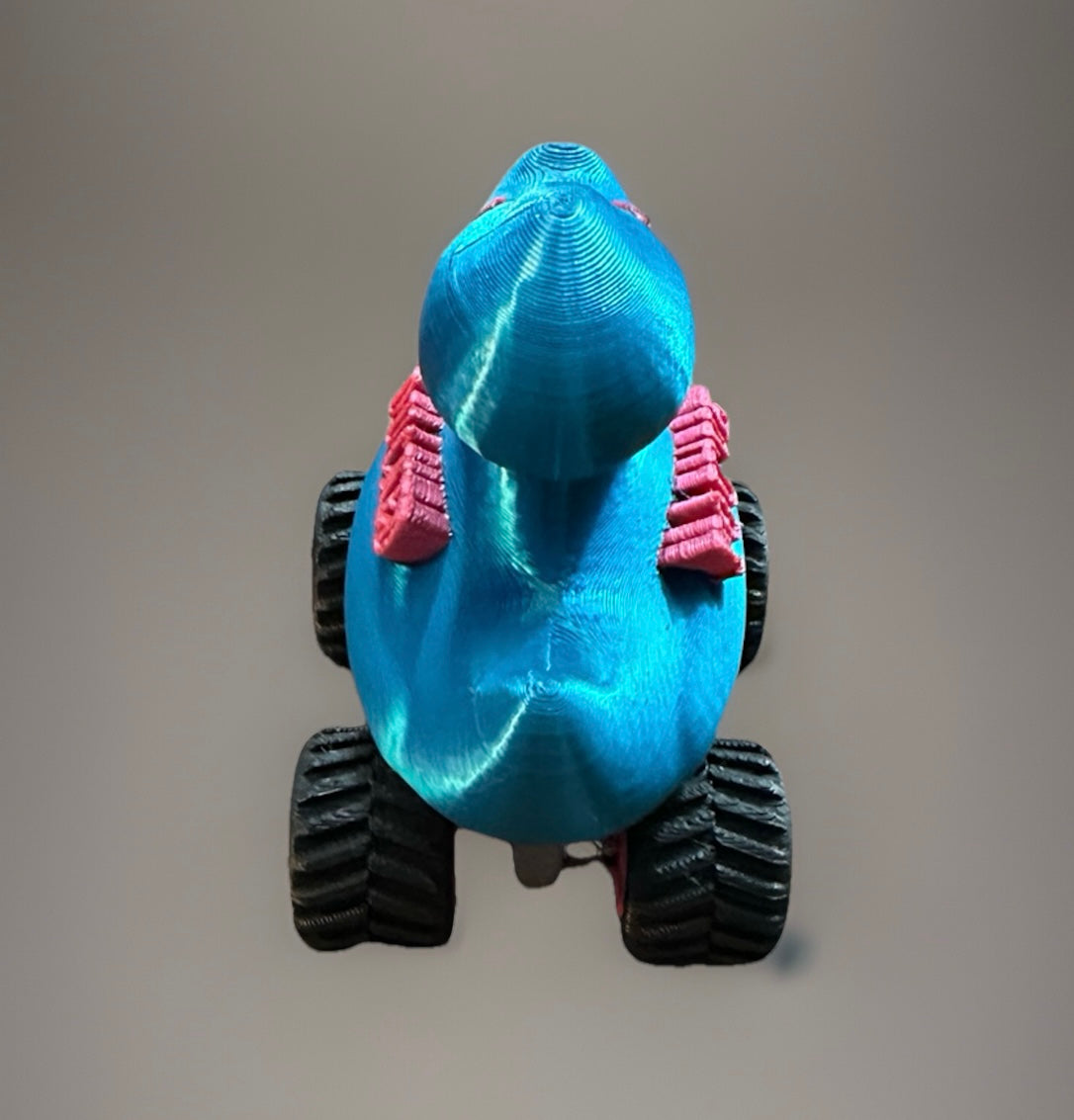Blue rubber duck with large black wheels and pink backpack accessory titled You've been ducked jeep